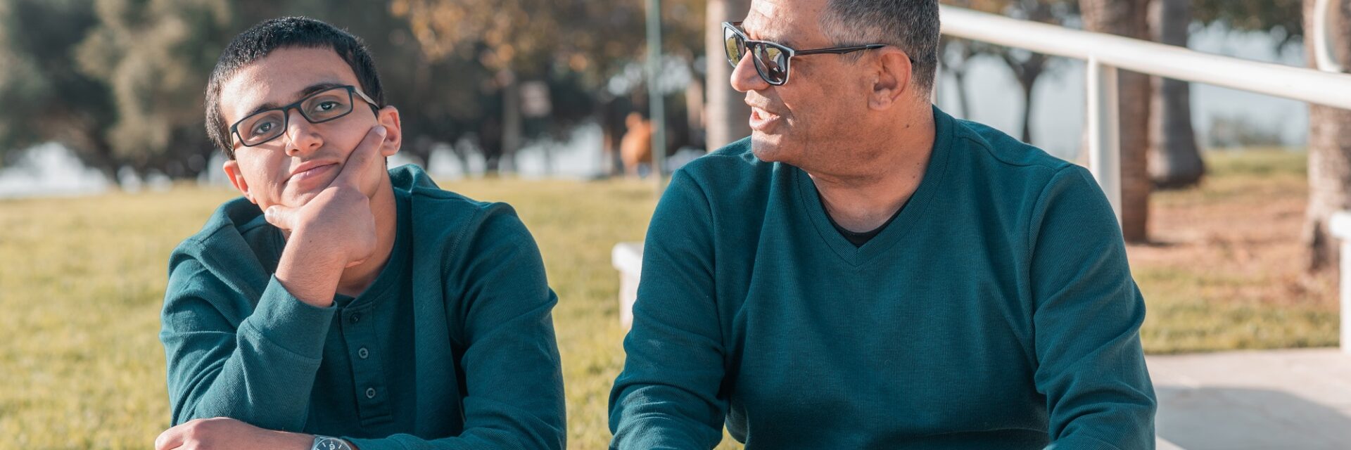 Teenage boy with Dad sat outside