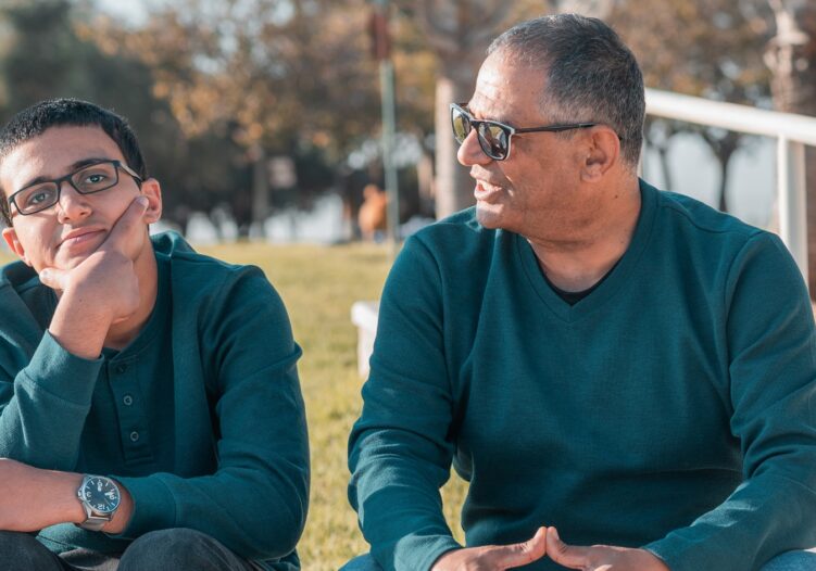 Teenage boy with Dad sat outside